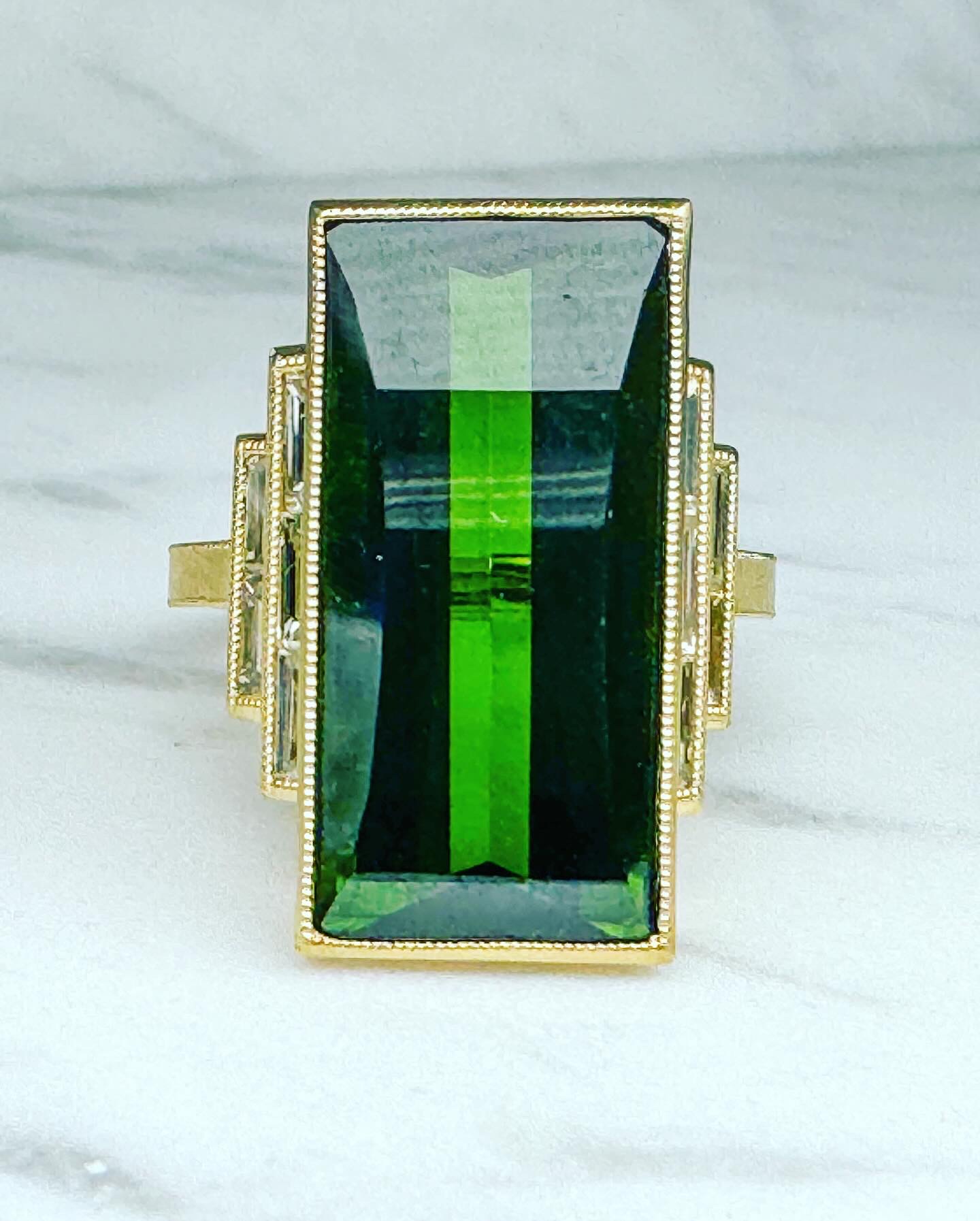 Green tourmaline statement ring with baguette diamonds in gold